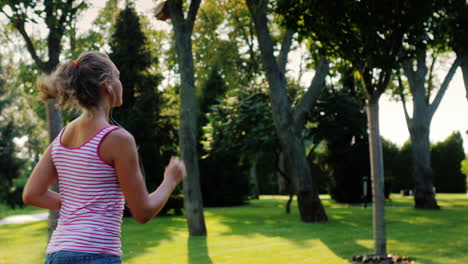 A-woman-runs-in-the-park-in-the-sun