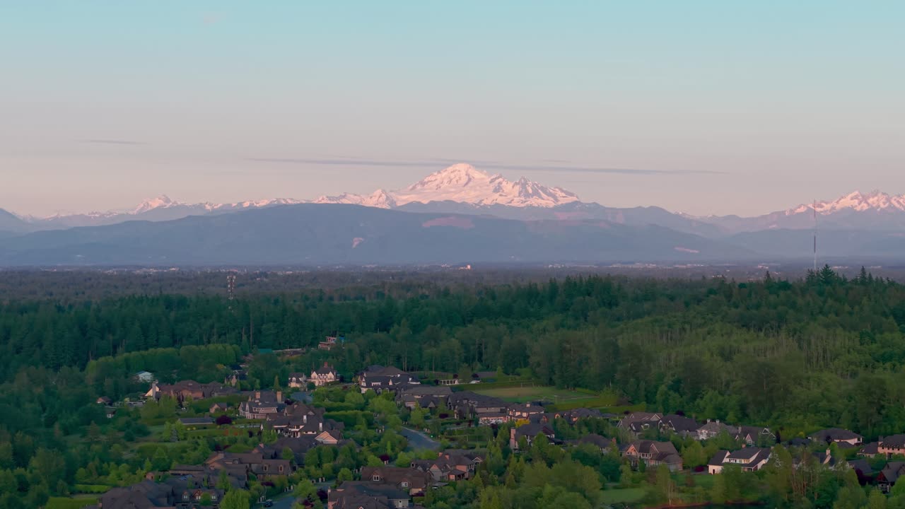 A scenic view of Mt Baker under a clear blue sky from Langley Township in British Columbia, Canada