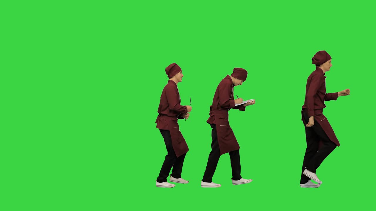 빨간 유니폼을 입은 두 명의 재는 요리사들이 초록색 화면에 요리법을 쓰고 있습니다.