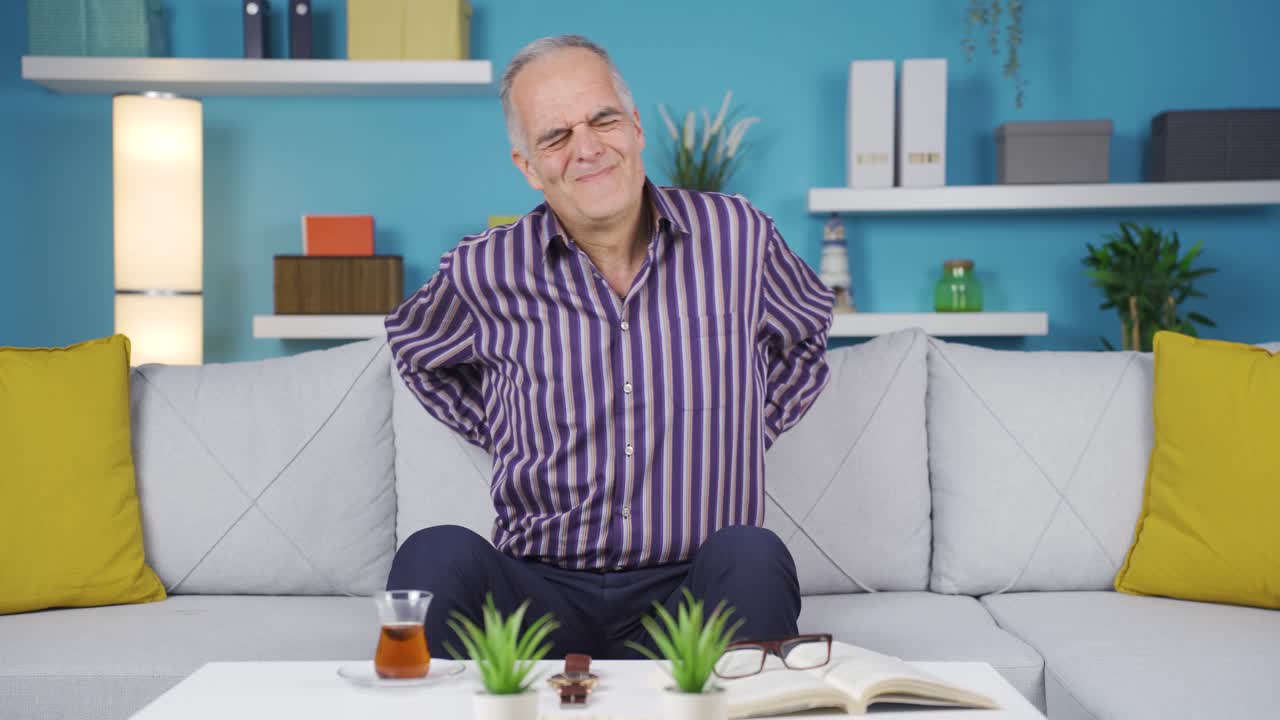 Old man with lower back and back pain suffering from pain.