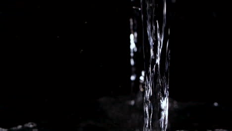 cool and refreshing water pouring into black background in slow motion hydration