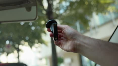 Action-Camera-Mount-Being-Placed-On-Windscreen-By-Driver