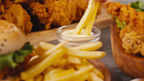 delicious french fries with crispy chicken and burgers