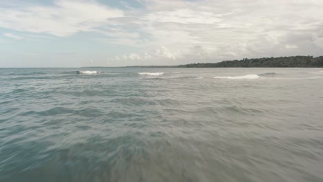 flying-over-the-sea-through-a-tropical-island,-punta-mona,-manzanillo,-costa-Rica