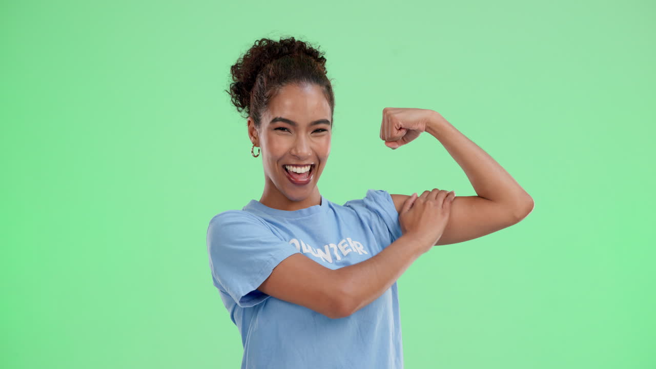 A happy volunteer showing off their bicep