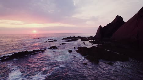 sunset over rocky coastline