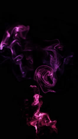 abstract pink and purple smoke particle swirls on black background