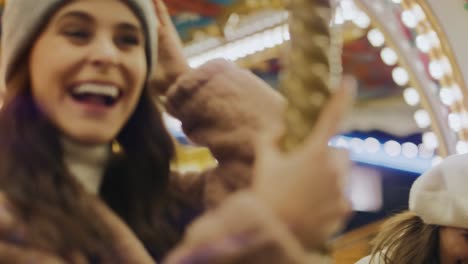 video of women having fun on carousel  in funfair