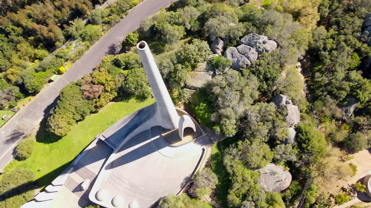 Descending drone view of historic Afrikaans language monument on Paarl Mountain