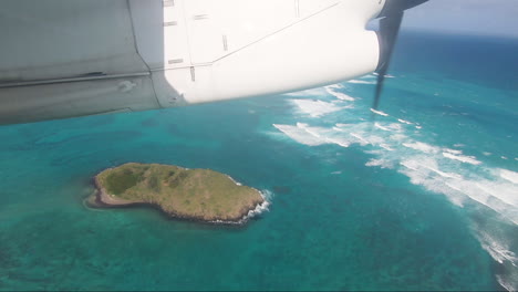 small commuter aircraft flying over rabbit island lord howe island pov aircraft window showing shadow of aircraft flying over small island in blue lagoon lord howe island australia