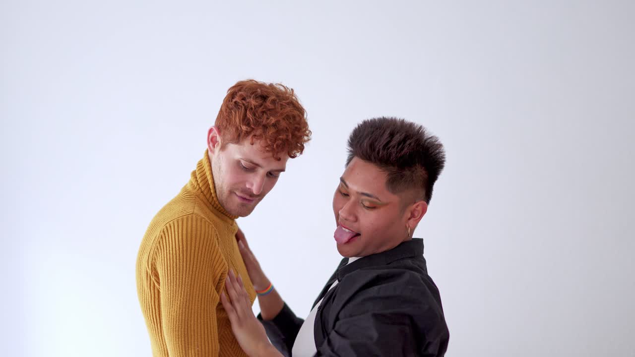 Two men embracing and showing affection on a white background