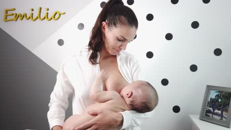 madre alegre con el bebé en el dormitorio