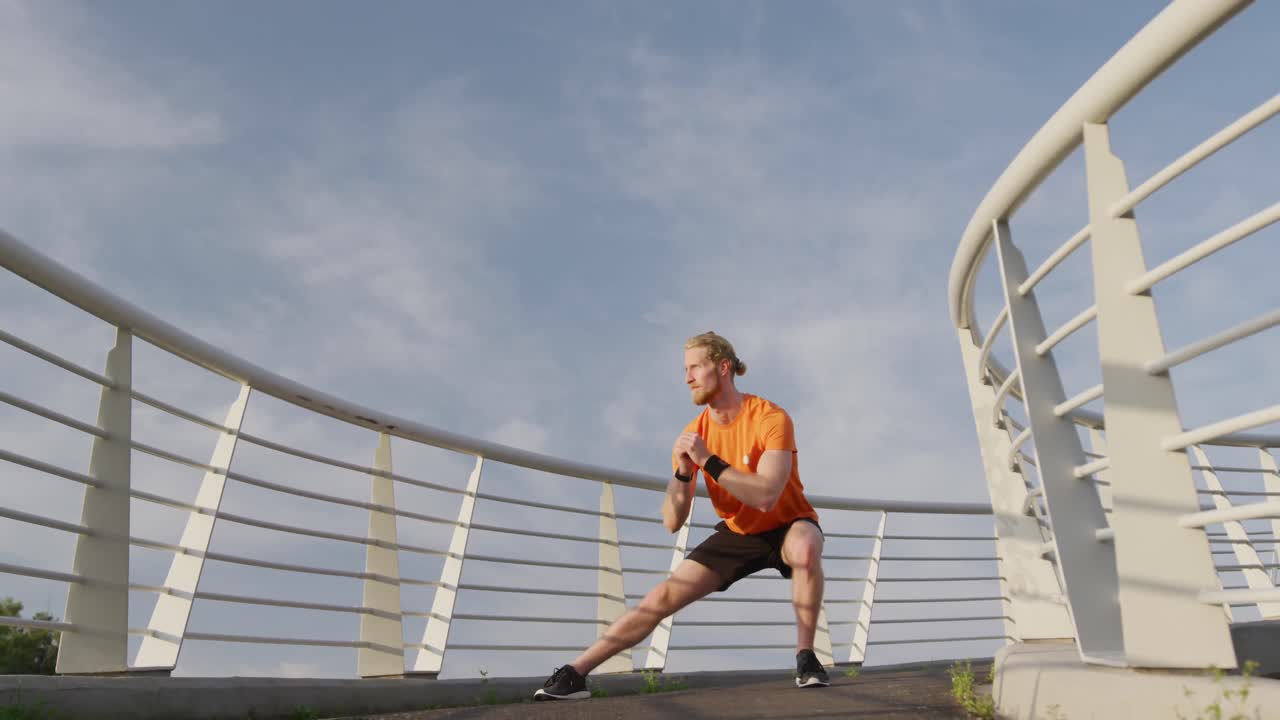 Sporty Caucasian man training on a bridge