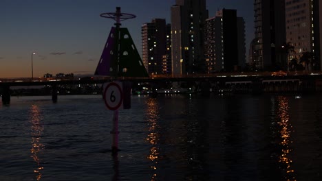 cityscape with illuminated buildings and water reflections