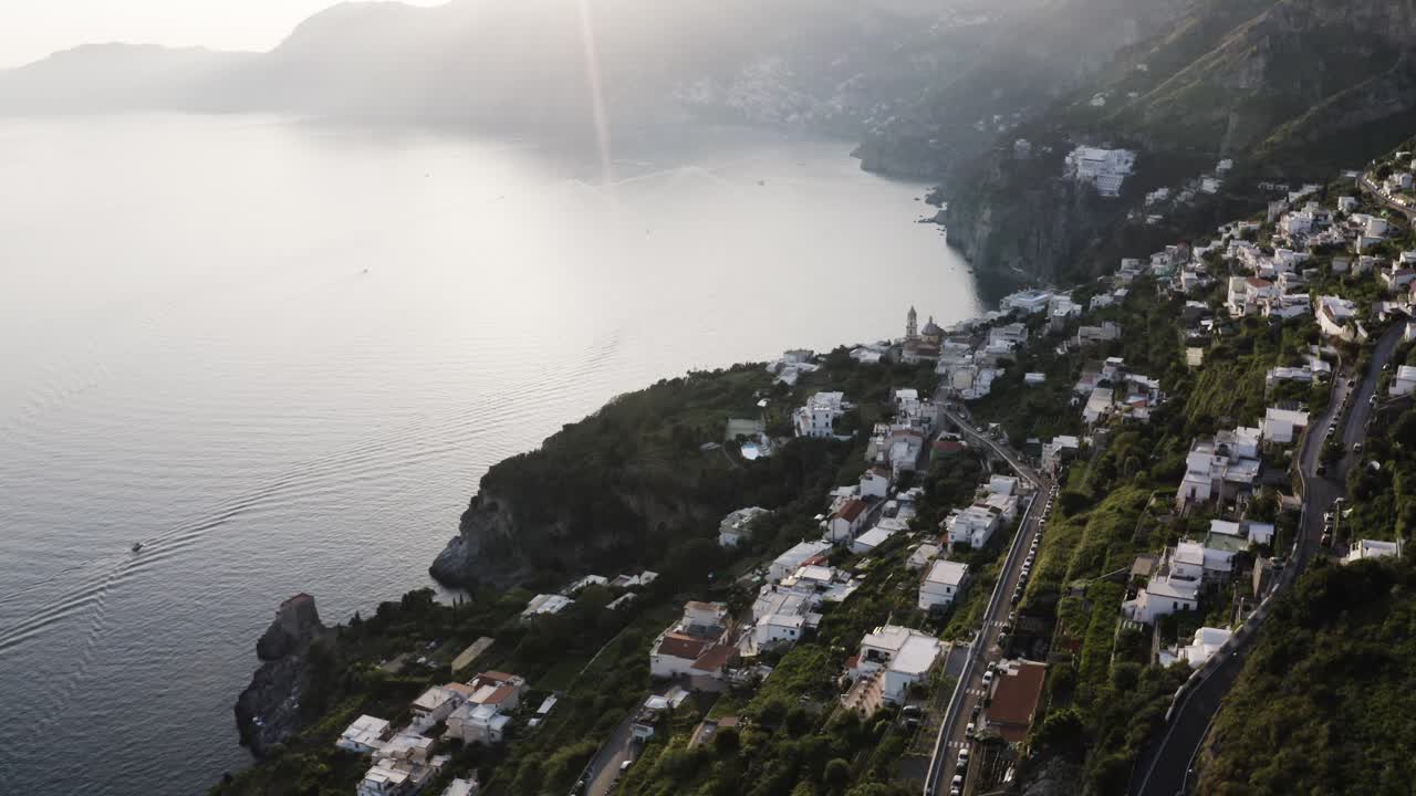 Wide establishing shot of Praiano, Italy's humble town overlooking the sea