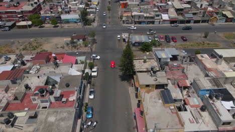 Aerial-top-down-tracking-view-vehicles-drive-in-Mexico-city-Ecatepec-north-neighborhood