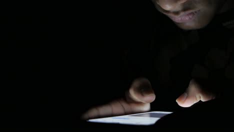 man using smartphone in the dark