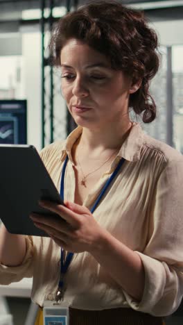 vertical video female office administrator using digital tools for kpi analytics