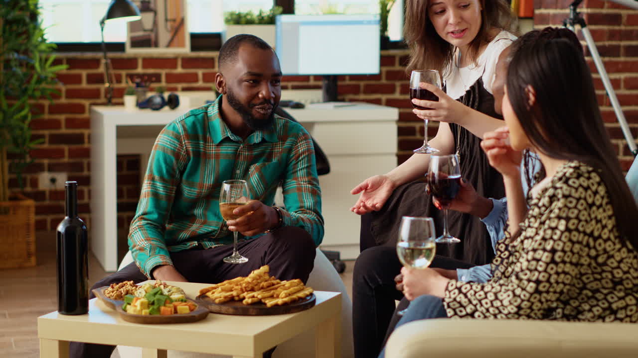 Smiling guests laughing in cozy living room after gifting host presents