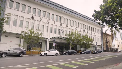 scientology building in san diego california - slow motion of black car driving by