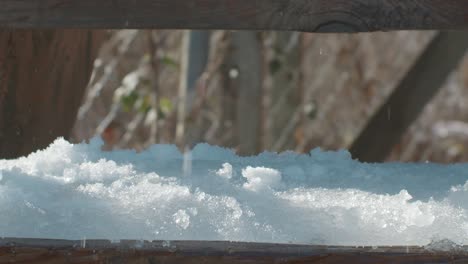 metallic ice scrapper breaking and removing ice on stair steps - slomo