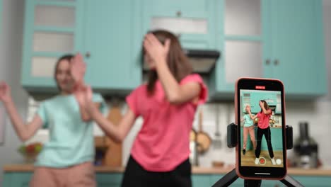 teenage girls dancing in the kitchen