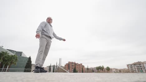 parkour athlete performing a frontflip in urban environment