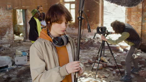 woman production worker setting up the microphone for a recording