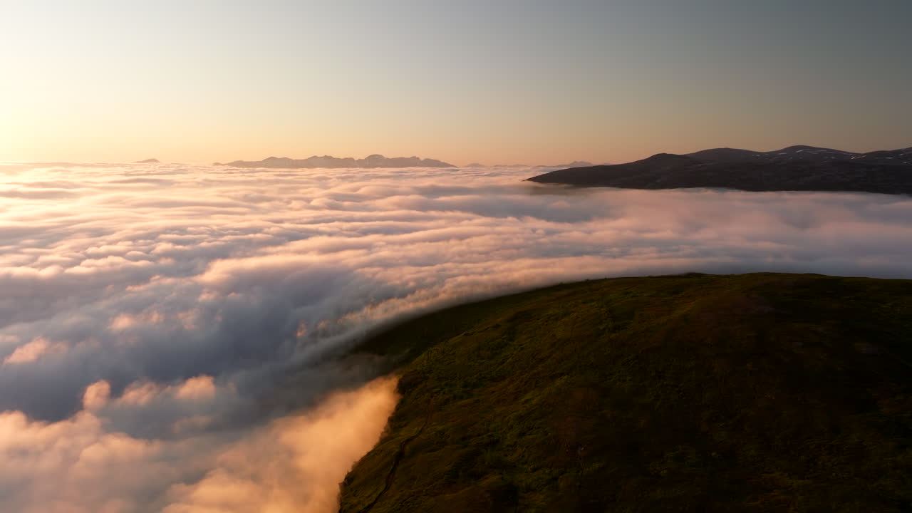 Stunning aerial above cloud inversion over Norwegian fjord during midnight sun