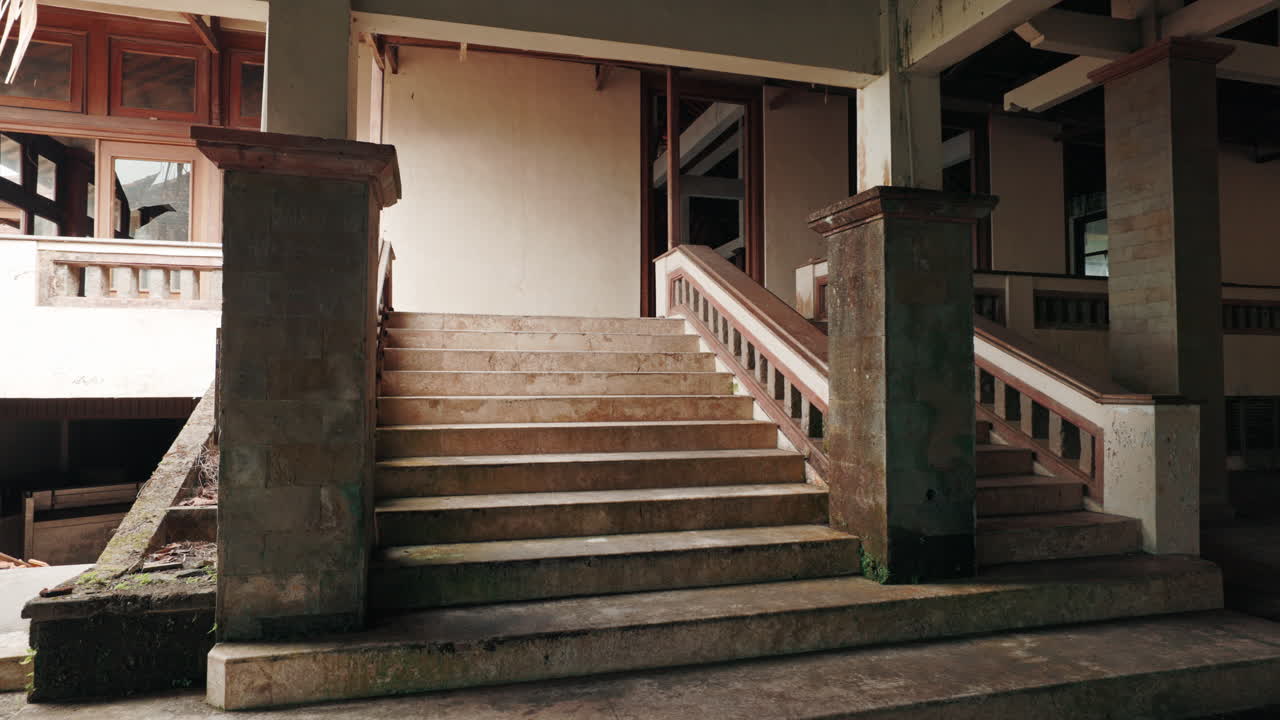 Abandoned Building Interior with Grand Stone Staircase