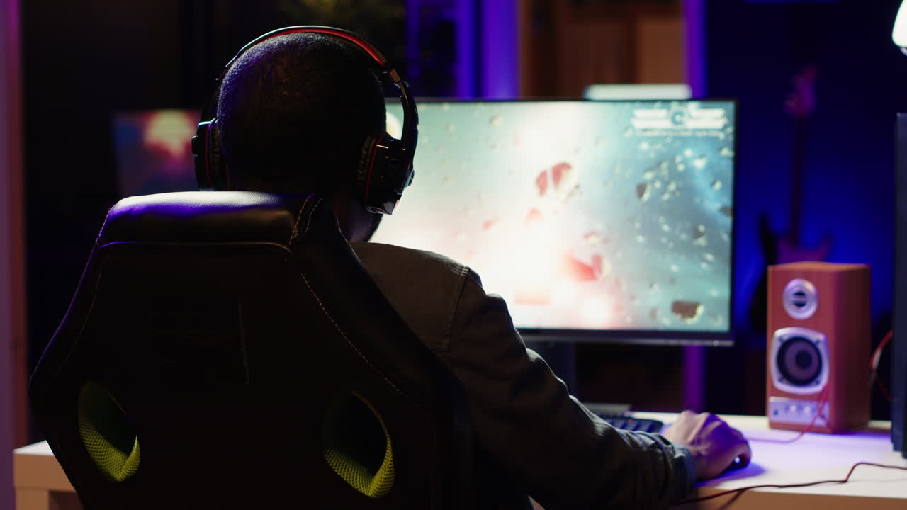 Pro gamer in gaming chair wearing headphones playing science fiction game