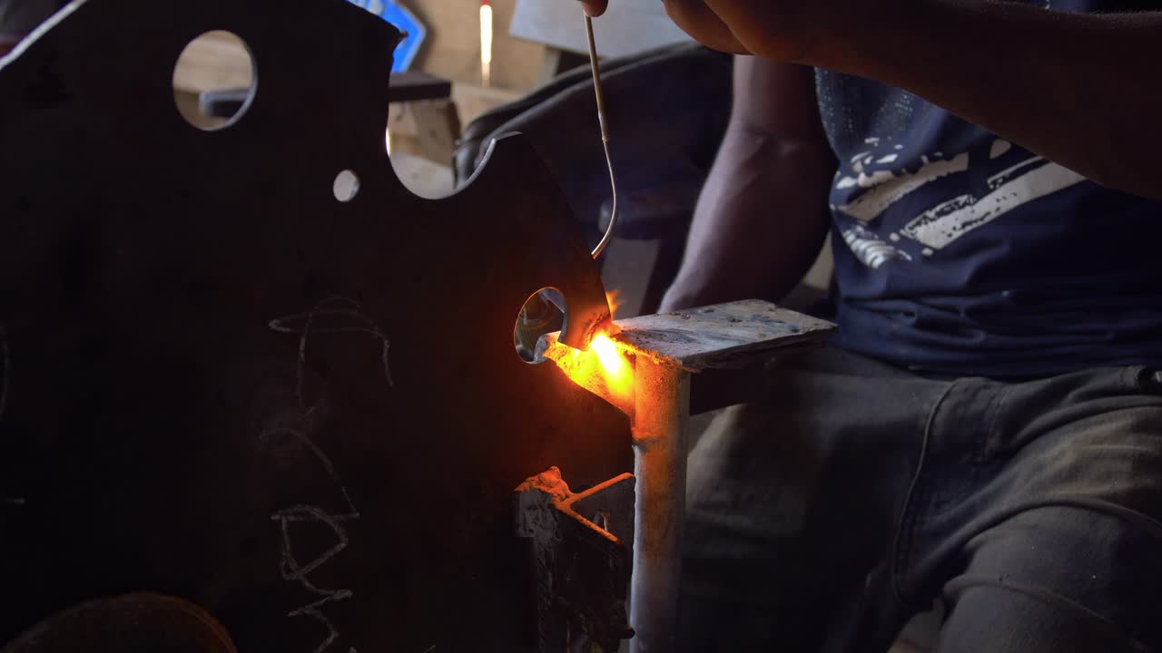 Tough Work of a black African Welder at Steel Making Factory