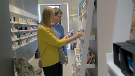 Young-couple-smelling-perfume-tester-in-the-shop