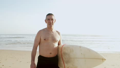 male surfer smiling at camera