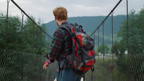 Two-hikers-walking-mountains-in-countryside.-Smiling-couple-traveling-in-nature.