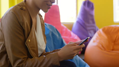 Side-view-of-young-caucasian-female-executive-talking-on-mobile-phone-in-modern-office-4k