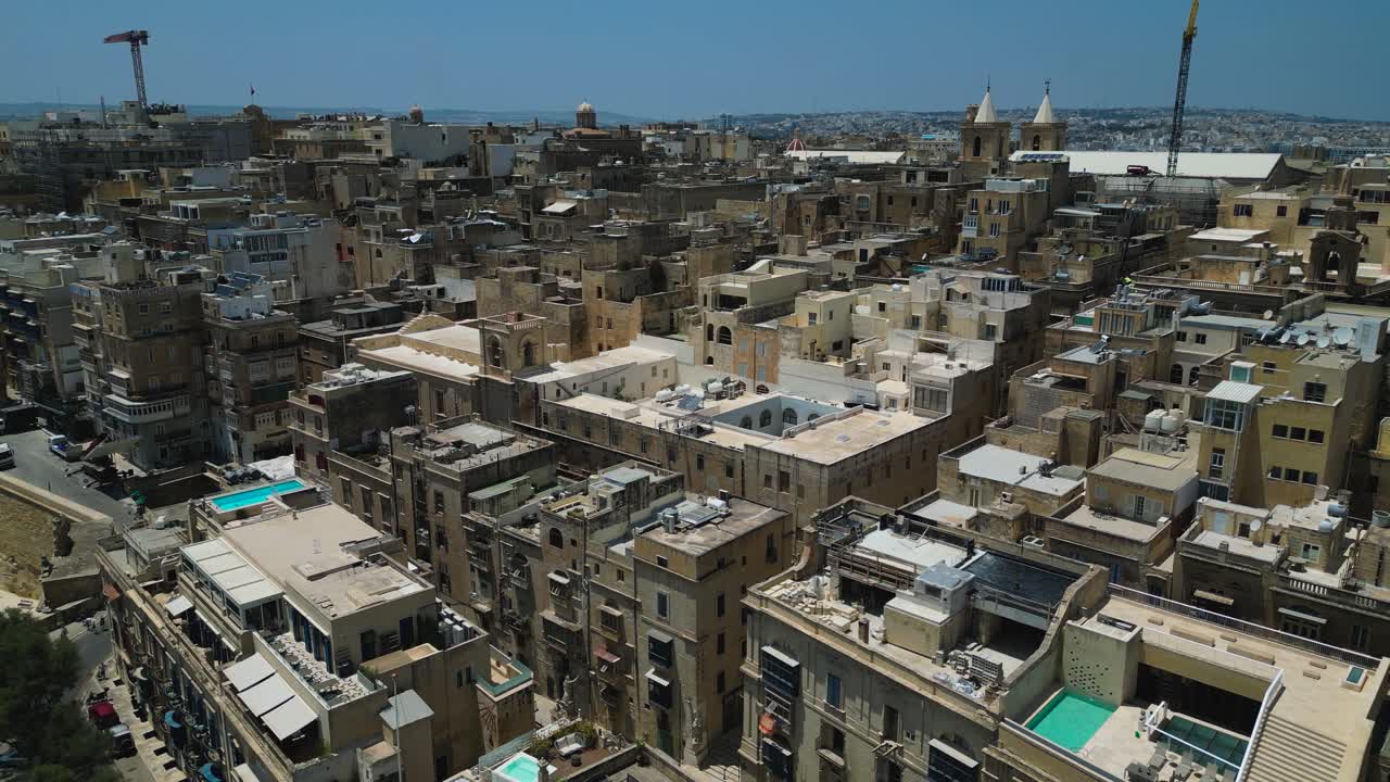 Slow pullback aerial view of buildings in Malta's capital city, Valletta