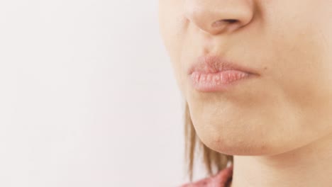 Woman-eating-chocolate-with-heart-in-close-up.-Eating-chocolate.