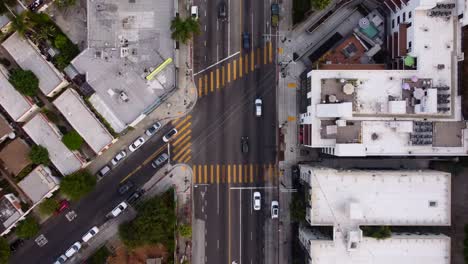 cars driving at junction with crosswalks in america