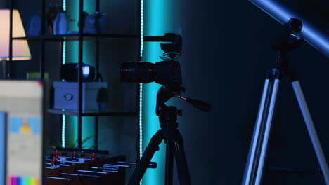 professional camera equipment in empty blue neon lit creative photography studio