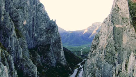 mountain ridge, vertigo shot, dolly zoom, immersive aerial shot of mountains of hidalgo, river stream in valley, epic cliff drone shot, portrero chico, mexican state of nuevo león