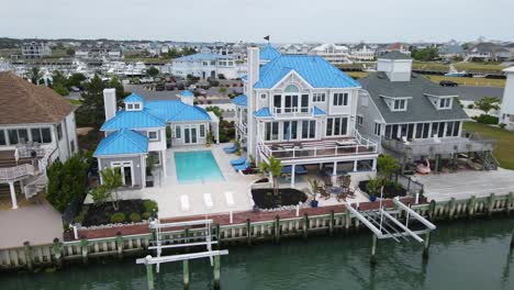 a smooth drone shot overlooking a beautiful mansion near assateague island