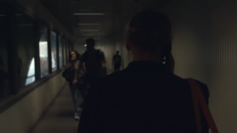 woman is walking through an underground passage