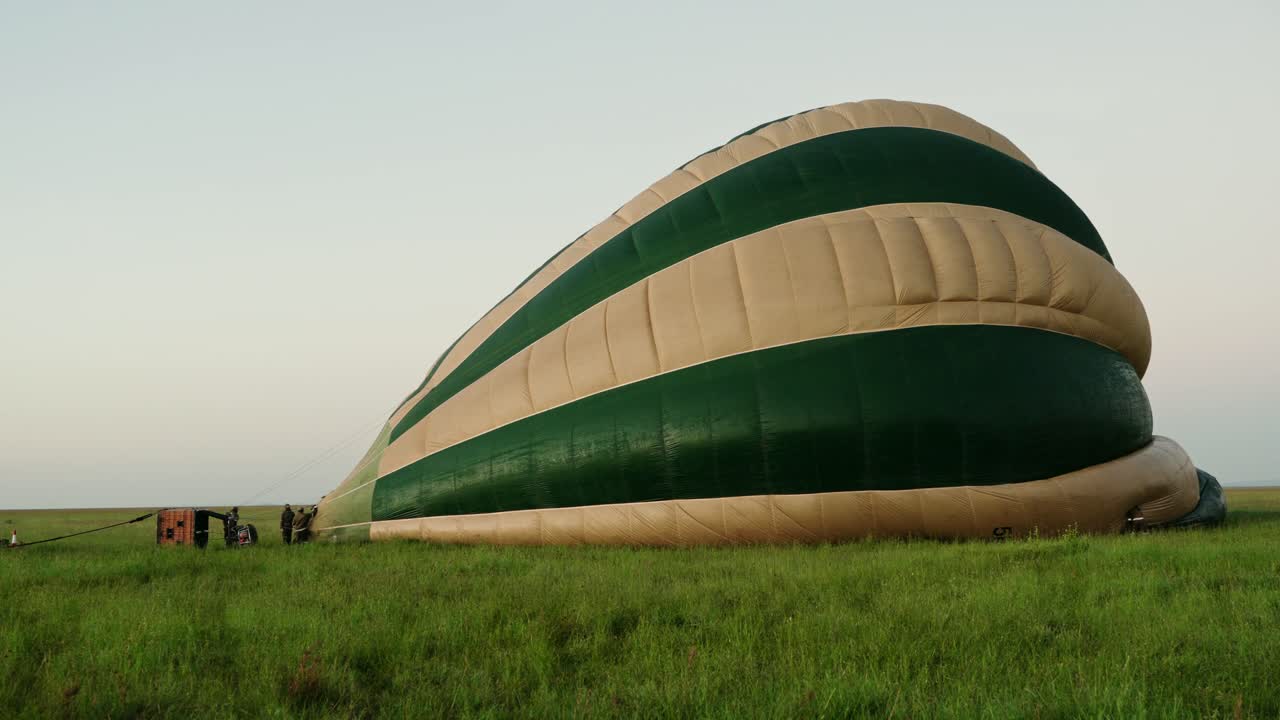 Hot air balloon being inflated at sunrise