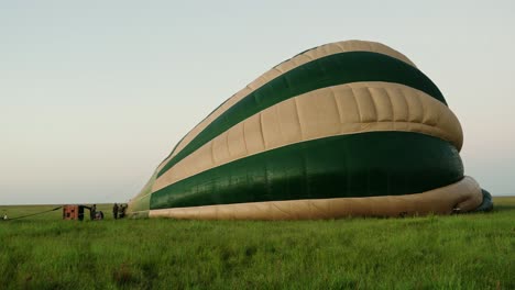 hot air balloon being inflated at sunrise