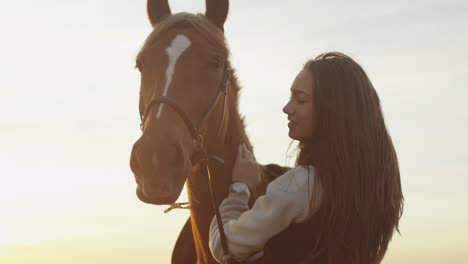 young girl stroking and hugging a horse