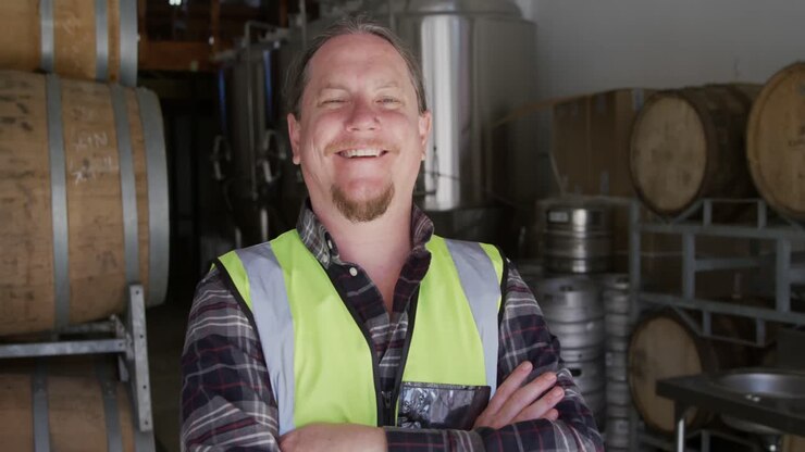 Caucasian man smiling at camera and wearing high visibility vest