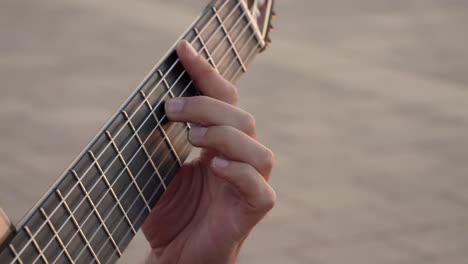 Unrecognizable-guitarist-playing-song-on-street