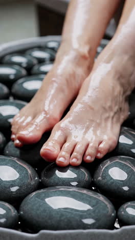 woman's feet on hot stones