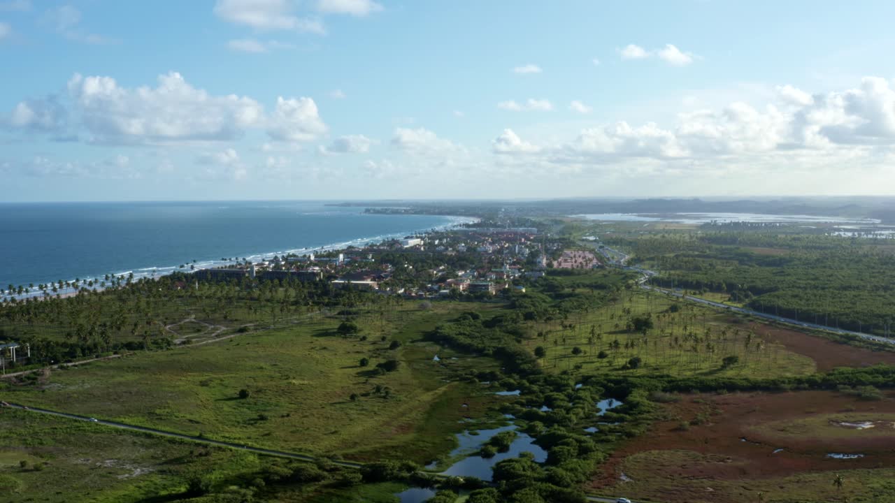 Tilt-up aerial drone shot revealing the beautiful tropical coastline of the famous tourist beach of Porto de Galinhas or Chicken Port in Pernambuco, Brazil on a warm sunny summer day